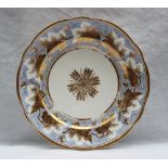 A Nantgarw porcelain plate with a scalloped edge and gilt leaf decoration, to a blue border,