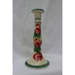 A Llanelly pottery candlestick decorated with tea roses and leaves with green line decoration,