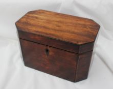 A 19th century mahogany tea caddy, of rectangular form with cut corners,