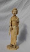 A 19th century Japanese ivory figure of a geisha, on a circular base with an inset red seal mark,