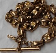 A yellow metal Albert chain with oval star engraved links, marked 10ct, approximately 34 grams, 40.