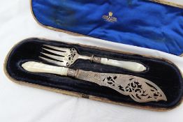 A pair of Victorian silver and mother of pearl handled fish servers, with a pierced blade and tines,
