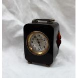 A Tortoise shell carriage clock, with a silver loop handle, on ball feet,