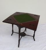 An Edwardian mahogany envelope card table, with a baize interior and counter wells,