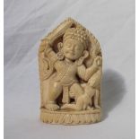 A 19th century carved ivory figure of an Indian God holding a sword in his right hand and the hair