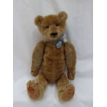 A mohair teddy bear with a movable head, arms and legs, with a hump back, and felt pads,