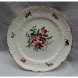 A Nantgarw porcelain plate painted to the centre with a spray of garden flowers,