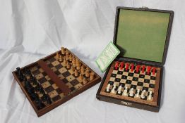 A travel chess set, with resin figures, the removable board contained within a leatherette case,