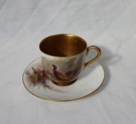 A Royal Worcester Cabinet cup and saucer, painted with pheasants, signed James Stinton,