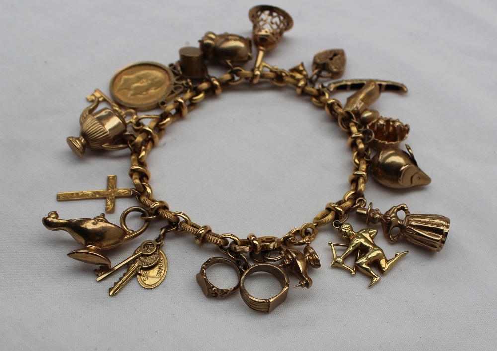 A 9ct yellow gold bracelet set with numerous charms including a half sovereign, pig, hand bell, - Image 3 of 3