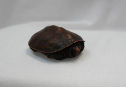 A Japanese box and cover in the form of a turtle, signed to the interior, bears a label "box,