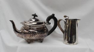 An Edward VII silver teapot, with a half gadrooned body on scrolling feet, London,