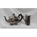 An Edward VII silver teapot, with a half gadrooned body on scrolling feet, London,