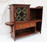 An Arts and Crafts mahogany wall cabinet, with a glass square cabinet, drawer and shelves,