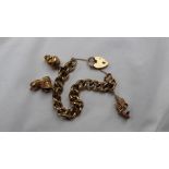 A 9ct yellow gold charm bracelet with oval textured links,