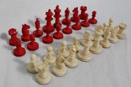 A bone chess set of classic Staunton shape, natural and stained red, King 5.2cm high, Pawn 1.