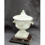 A Swansea porcelain urn and cover, heavily encrusted with flower heads and leaves, on a square base,