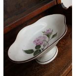 A Swansea pottery Moss Rose painted pedestal dish, of shaped oval form, with a brown rim,