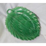 A Glamorgan pottery green leaf dish, with a twig handle, star mark impressed to the base,