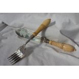 A Victorian silver and ivory fish servers, the blade and fork engraved with flower heads and leaves,