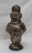A late Victorian silver sugar caster with a pierced domed top above a twisted inverted baluster