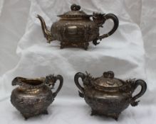 A Chinese silver three piece tea set, comprising a teapot,