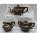 A Chinese silver three piece tea set, comprising a teapot,