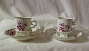 A pair of 18th century Vienna porcelain trembleuse tea cups and saucers painted with garden flowers