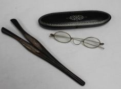 An ebony and silver mounted glove stretchers together with a pair of spectacles and a white metal