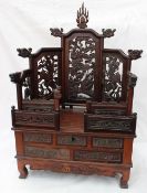 A Chinese hardwood table top shrine, with carved panels,