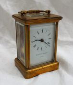 A brass cased carriage clock the enamel dial with Roman numerals inscribed Matthew Norman, London,