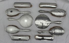 A George V silver part dressing table set, comprising a hand mirror,