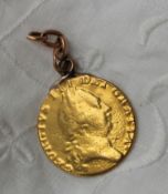 A George III gold shield back guinea, mounted on a chain, date indistinct,