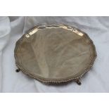 A George V silver salver, with a shaped gadrooned edge on four hoof feet, Chester, 1912,