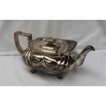A late George III silver teapot of squat oval form with wave decoration, on lions paw feet, London,