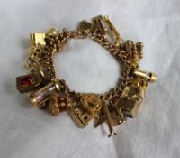 A 9ct yellow gold charm bracelet, set with numerous charms including a teddy bear, chalet,