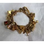 A 9ct yellow gold charm bracelet, set with numerous charms including a teddy bear, chalet,