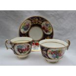 A Swansea trio tea cup, breakfast cup and saucer, painted with vignettes of flowers, in a gilt oval,