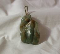 A jade carving of a fish and leaves,