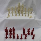 A 19th century Chinese ivory puzzle ball part chess set, natural and stained red,