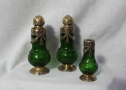 A George V silver gilt and green glass cruet set, comprising a salt, pepperette and oil pot,