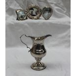 A George III silver helmet shaped cream jug on a pedestal foot, London, 1783,