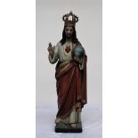 A carved pine polychrome decorated figure of Jesus Christ, wearing a crown,