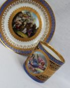 A Vienna style porcelain cabinet coffee can and saucer decorated with a roundel of an angel to gilt
