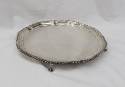 A George V silver salver, with a shaped gadrooned top on four claw and ball feet, Sheffield, 1933,
