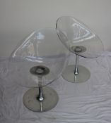 A pair Eros Kartell transparent plastic swivel chairs designed by Philippe Starck for Kartell,