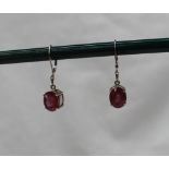 A pair of 18ct white gold and ruby drop earrings,