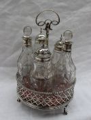 A early George III silver cruet stand, with a leaf hoop handle,