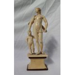 A 19th century ivory figure group of a naked maiden, with a swag of cloth concealing her modesty,