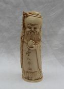A 19th century Chinese carved ivory figure of Shou Lao, holding a dragon headed staff and a peach,